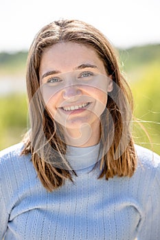 Sunny Day Portrait of a Smiling Young Woman