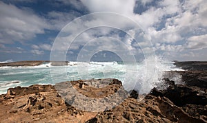 Sunny day with storm waves crashing into Laie Point coastline at Kaawa on the North Shore of Oahu Hawaii United States