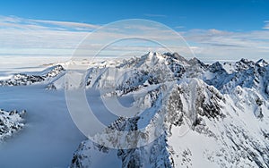 Sunny day in winter snowy mountains