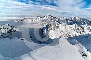 Sunny day in winter snowy mountains