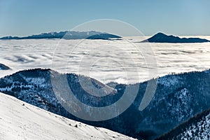 Sunny day at winter Little Fatra mountains ridge above clouds