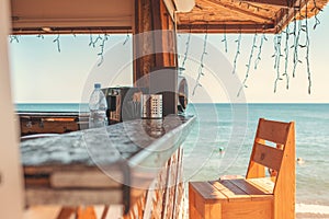 Sunny. An empty bar counter and an empty chair against the background of the beach and the sea. Vacation and summer