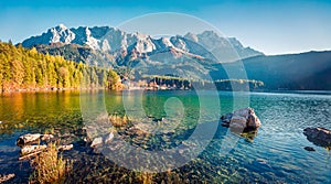 Sunny evening scene of Eibsee lake with Zugspitze mountain range on background. Beautifel autumn view of Bavarian Alps, Germany,