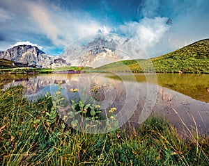 Sunny evening view of Baita Segantini mountain refuge with Cimon della Pala peak. Splendid summer scene of Dolomiti Alps, Rolle