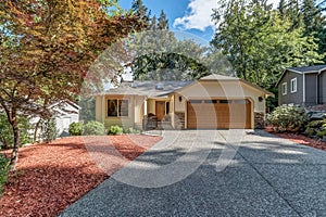 Sunny exterior home on sunny day. large driveway