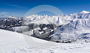 Sunny frosty day. Blue clear sky over mountain ridges in the snow.