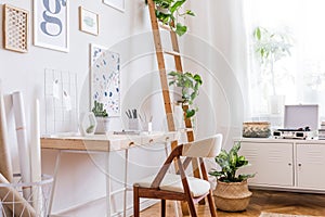 Sunny home office space with stylish furnitures and accessories.