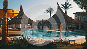 Sunny Hotel Resort with Blue Pool, Palm Trees and Sunbeds in Egypt