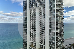 Sunny Isles Beach city with luxurious highrise hotels and condo buildings on Atlantic ocean shore. American tourism