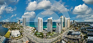 Sunny Isles Beach city with luxurious highrise hotels and condo buildings and busy ocean drive on Atlantic coast