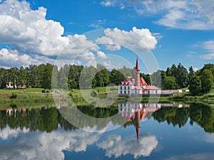 Sunny landscape with old castle on the pond. Russia. Gatchina city