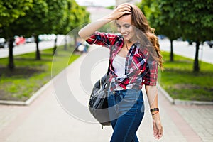 Sunny lifestyle fashion portrait of young stylish hipster woman walking on the street