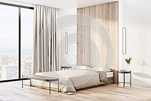 Sunny light shadows bedroom with beige colors interior design, modern bed with wooden recess, parquet and city view from floor-to-