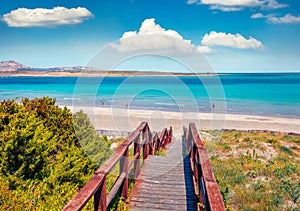 Sunny maribe scenery. Wooden footbridge to the oasis-like beach - Spiaggia della Pelosa