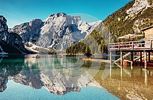 Sunny morning at Famouse Mountain Lake in dolomites Alps. Wonderful Braies Lake during sunrise. Amazing Summer Mountain Landscape