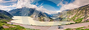 Sunny morning panorama of the coast of Grimselsee reservoir on t