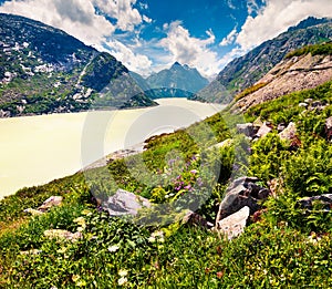 Sunny morning view from the coast of Grimselsee reservoir on the