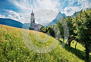 Sunny morning view of San Valentino Church in Castelrotto/Kastelruth village. Exciting summer scene of Dolomiti Alps, Bolzano,
