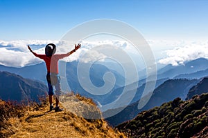 Sunny Mountains cloud Horizon and Hiker with Arms raised spread photo