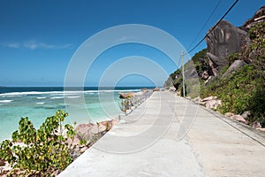 Sunny oceanside road on La Digue, Seychelles