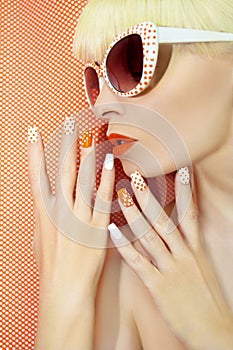 Sunny orange manicure and makeup.