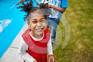 Sunny Poolside Glee: Afro-American Girl's Infectious Laughter by the Water