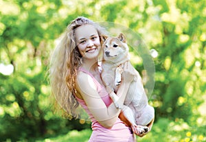 Sunny portrait charming pretty girl and her loving dog outdoors