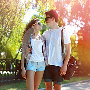 Sunny portrait of happy young couple teenagers in urban style