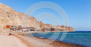 Sunny resort beach at the coast shore of Red Sea in Dahab, Sinai, Egypt, Asia in summer hot. Famous tourist destination Blue Hole