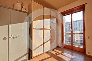 Sunny room with wardrobe and safe in apartment interior