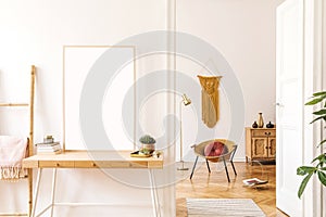 Sunny scanidnavian interiors of home apartment with mock up poster frame, wooden ladder, gold armchair, design accessories. photo