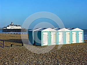 Sunny scenery of beach huts in Eastbourne Pier, Eastbourne, UK