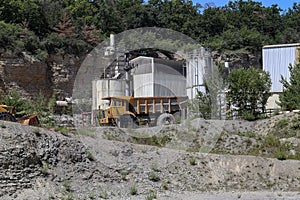 Sunny scenery of a sand mining process in an industrial quarry