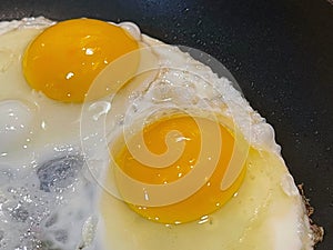 Sunny side up eggs frying in the frying pan