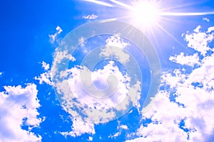 Sunny simple blue sky cloudscape background photograph with sun rays