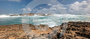 Sunny sky over storm waves crashing into Laie Point coastline at Kaawa on the North Shore of Oahu Hawaii United States