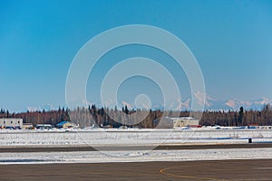 Sunny snowy view of airport with Mount McKinley photo