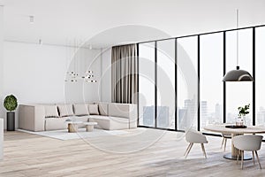 Sunny spacious light shades living room with transparent glass wall, big beige sofa, parquet and modern dinner table
