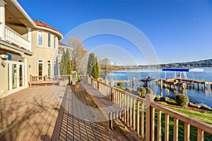 Sunny spacious walkout deck of luxurious waterfront home