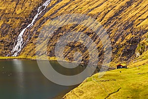 Sunny spring view of Saksun village with typical turf-top houses, Faroe Islands