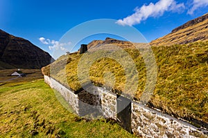 Sunny spring view of Saksun village with typical turf-top houses, Faroe Islands