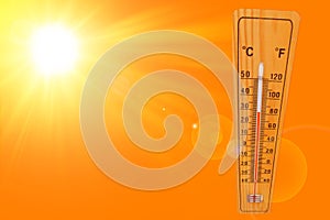 Sunny summer background with the thermometer marking a temperature over 27 degrees and bright sun on an orange background