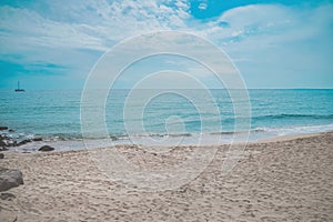 Sunny summer beach ocean waves with bubbles and sand background