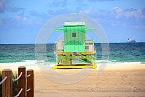 Sunny summer day, with blue sky and Atlantic Ocean. Miami South Beach lifeguard tower and coastline with cloud and blue