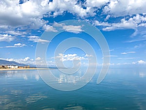 Sunny summer day on the lake. Mountains and sea. Kyrgyzstan, Lake Issyk-Kul