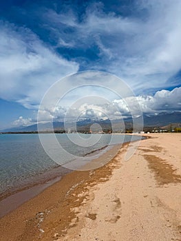 Sunny summer day on the lake. Mountains and sea. Kyrgyzstan, Lake Issyk-Kul