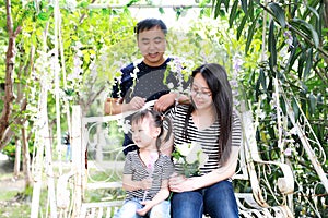 Happy family parental activity mother father daughter hand in hand play and have fun outdoor in summer park child parent love girl