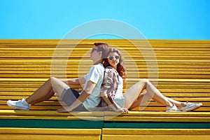 Sunny summer portrait stylish young cool couple teens rest