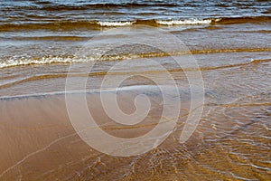 sunny summer scene of Baltic sea with beautiful seaside with waves.