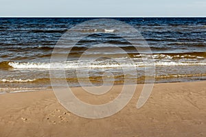 sunny summer scene of Baltic sea with beautiful seaside with waves.